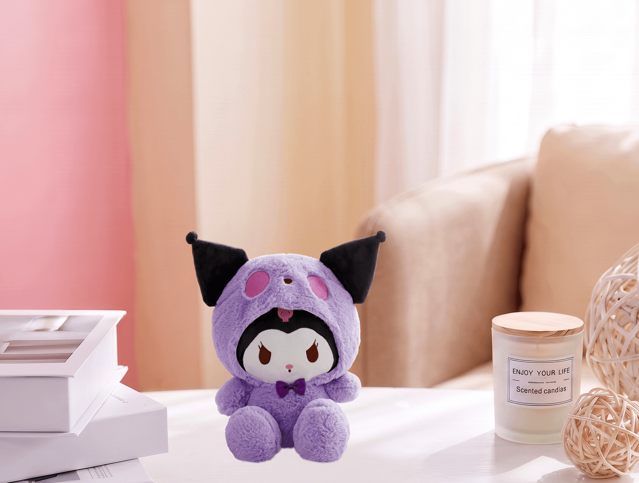 Purple kawaii character plush toy displayed on table with scented candle and books